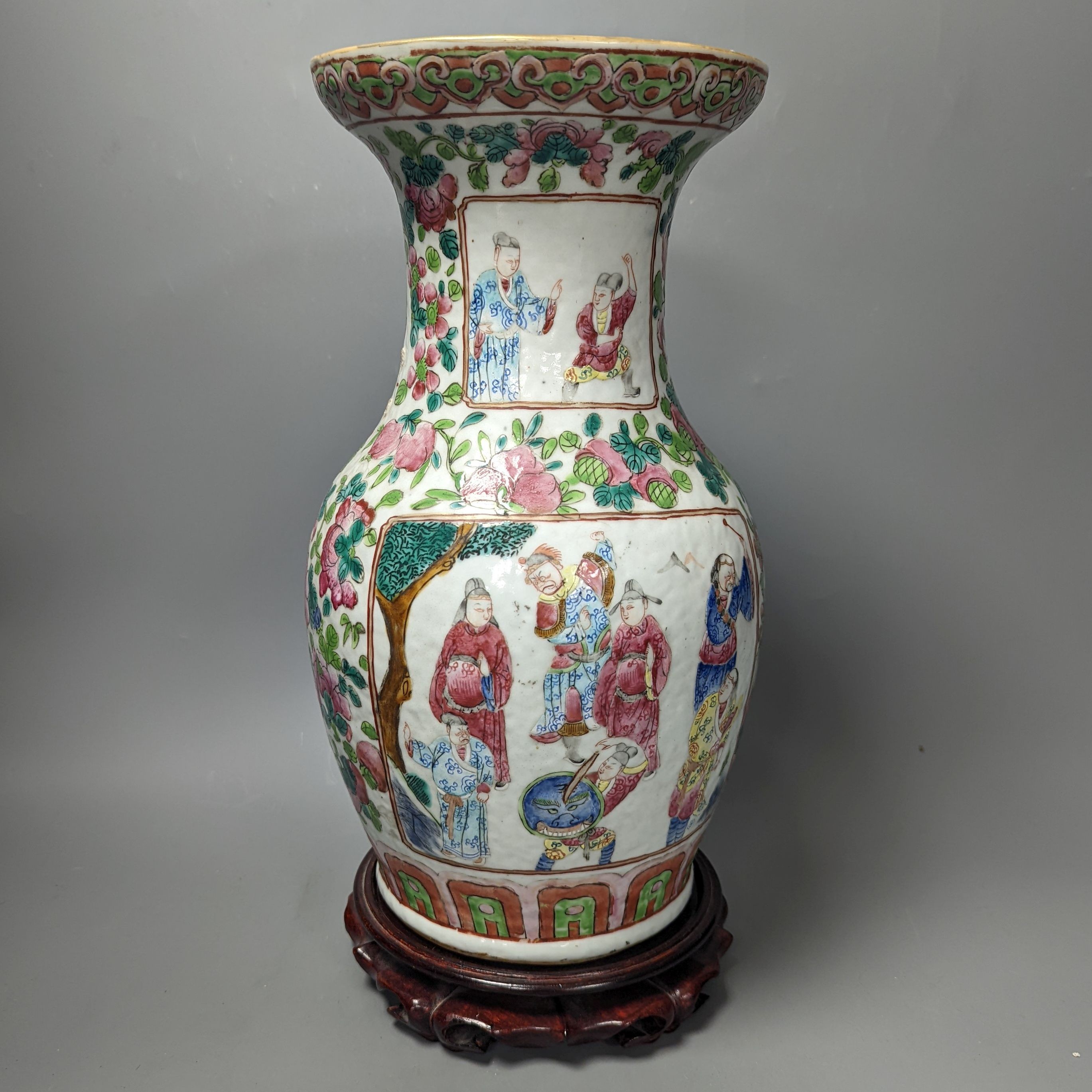 A 19th century Chinese famille rose vase on wooden stand, 37 cms high including stand.